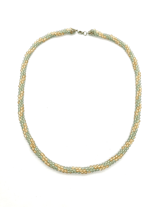 A delicate beaded necklace with a twisted design in green and gold tones.