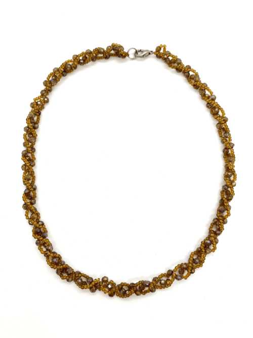 A twisted beaded necklace with amber-colored beads.