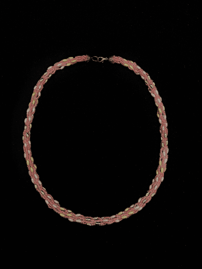 A classic red and white beaded necklace with a twisted design.