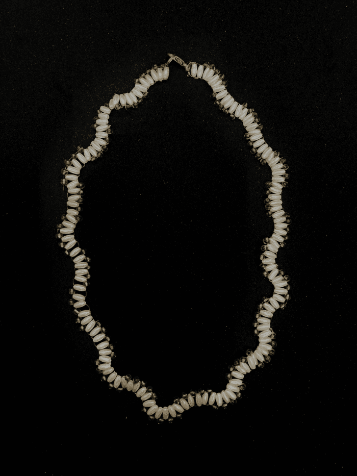 A multi-strand white pearl necklace with a wave-like pattern