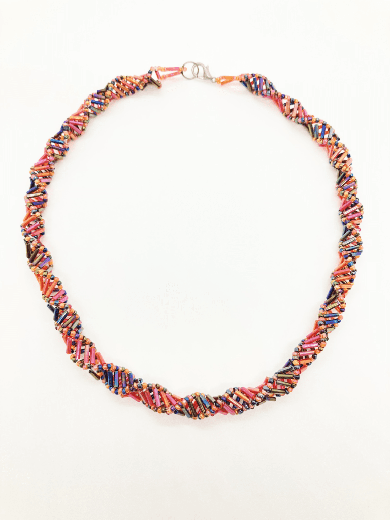 Bohemian-style beaded necklace with a spiral design and vibrant colors.