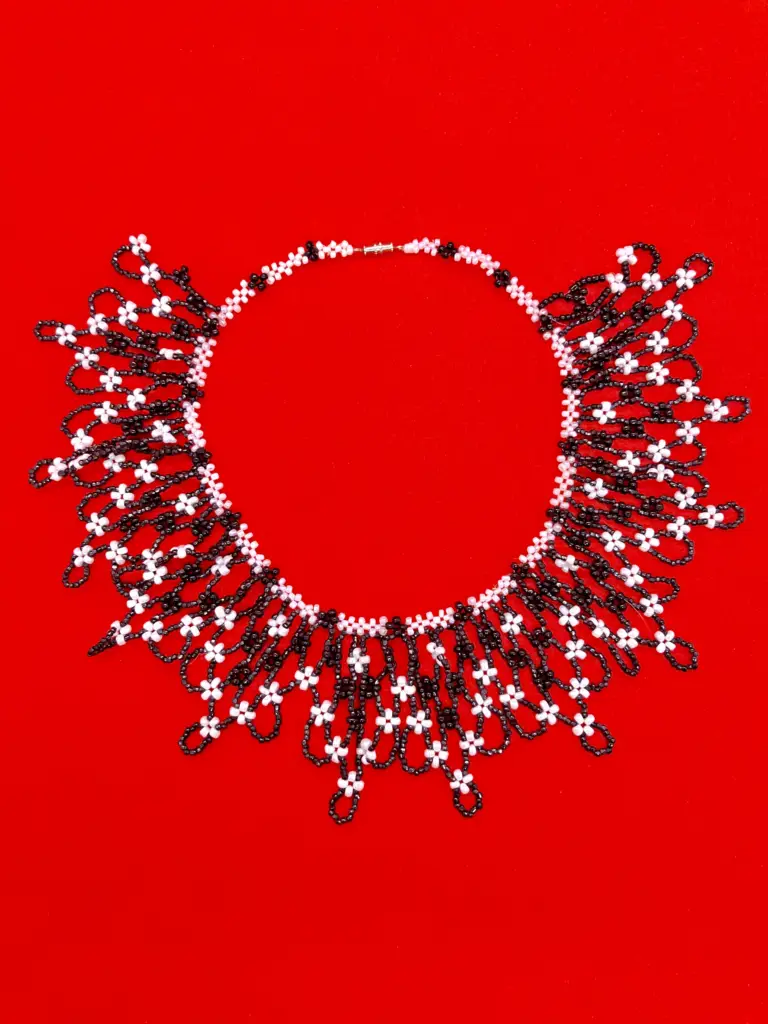 elegant beaded jewelry, Intricate black and white beaded necklace with a floral motif