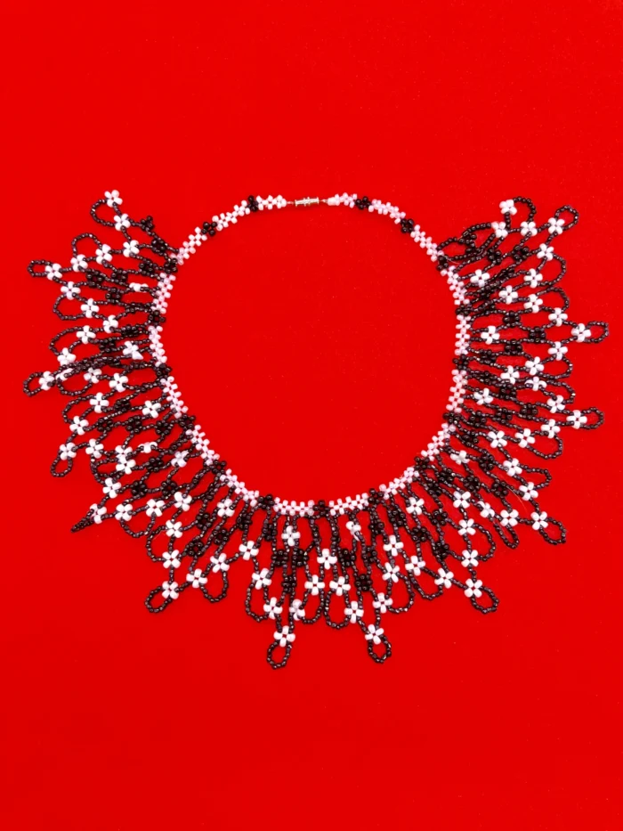 Elegant Black and White Glass Bead Necklace on Red Background